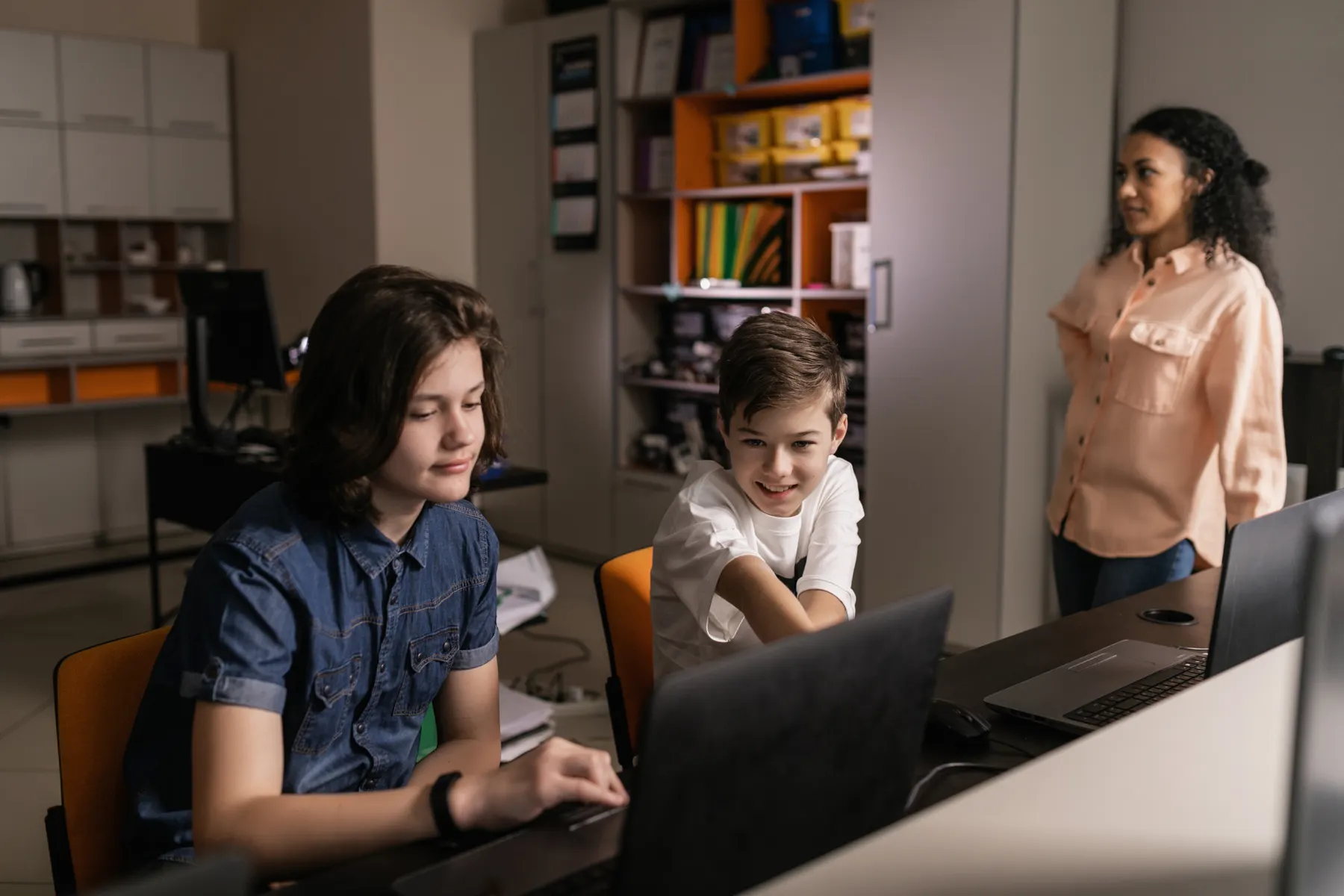 Students using computers in a classroom with teacher guidance
