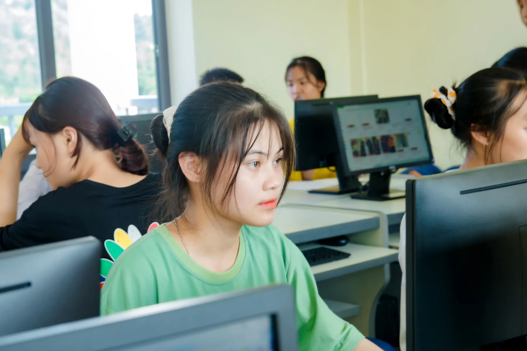 Student completing a digital lesson in a school computer lab